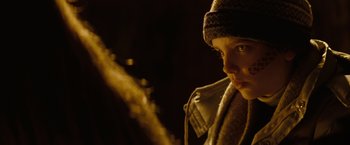 Movie still from “Let Me In” (2010), directed by Matt Reeves – A young boy wearing a hat and a scarf; Close Up shot, Over the shoulder angle