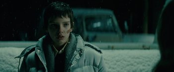 Movie still from “Let Me In” (2010), directed by Matt Reeves – A boy in a white jacket standing in the snow; Close Up shot, Over the shoulder angle