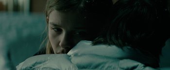 Movie still from “Let Me In” (2010), directed by Matt Reeves – A woman is hiding her face behind a blanket; Close Up shot, Over the shoulder angle