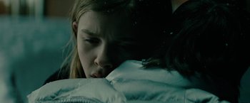Movie still from “Let Me In” (2010), directed by Matt Reeves – A young girl sleeping on a bed in the snow; Close Up shot, Low angle