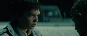 Movie still from “Let Me In” (2010), directed by Matt Reeves – A young boy is sitting in the back of a car; Close Up shot, Low angle