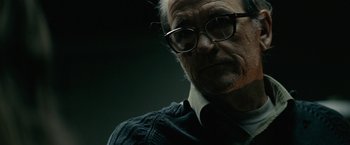 Movie still from “Let Me In” (2010), directed by Matt Reeves – An older man wearing glasses and a sweater; Close Up shot, Low angle