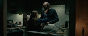 Movie still from “Let Me In” (2010), directed by Matt Reeves – A man and a woman in a kitchen; Medium shot, Over the shoulder angle