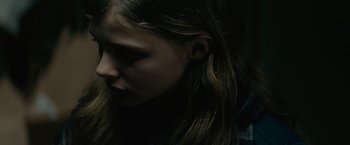 Movie still from “Let Me In” (2010), directed by Matt Reeves – A person with long hair; Close Up shot, Over the shoulder angle