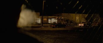 Movie still from “Let Me In” (2010), directed by Matt Reeves – A car parked in front of a building at night; Extreme Wide shot, Low angle
