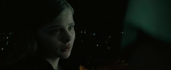Movie still from “Let Me In” (2010), directed by Matt Reeves – A young girl is looking into the distance; Close Up shot, Low angle