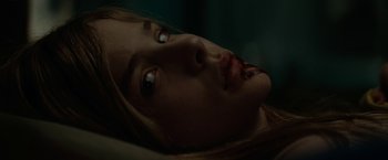 Movie still from “Let Me In” (2010), directed by Matt Reeves – A young woman with a bite of food in her mouth; Close Up shot, Low angle