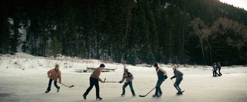 Movie still from “Let Me In” (2010), directed by Matt Reeves – A group of men playing a game of ice hockey; Extreme Wide shot, High angle