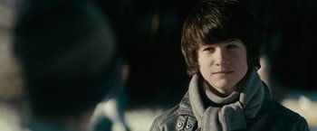 Movie still from “Let Me In” (2010), directed by Matt Reeves – A young man wearing a leather jacket and a scarf; Close Up shot, Over the shoulder angle