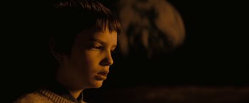Movie still from “Let Me In” (2010), directed by Matt Reeves – A young boy is looking into the distance; Close Up shot, Over the shoulder angle