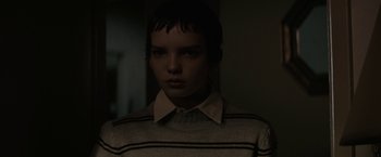 Movie still from “Let Me In” (2010), directed by Matt Reeves – A woman with short hair wearing a striped shirt; Medium shot, Over the shoulder angle