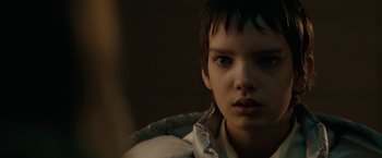 Movie still from “Let Me In” (2010), directed by Matt Reeves – A young boy is looking into the camera; Close Up shot, Over the shoulder angle