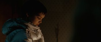 Movie still from “Let Me In” (2010), directed by Matt Reeves – A young boy is looking down at the floor; Close Up shot, Over the shoulder angle