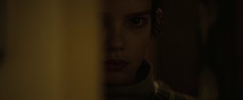 Movie still from “Let Me In” (2010), directed by Matt Reeves – A person's face in the dark; Close Up shot, Over the shoulder angle