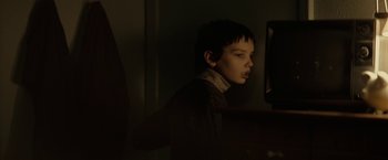 Movie still from “Let Me In” (2010), directed by Matt Reeves – A young boy looking at a computer screen; Medium shot, Over the shoulder angle