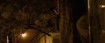 Movie still from “Let Me In” (2010), directed by Matt Reeves – A young boy leaning up against a brick wall; Medium shot, Low angle
