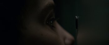 Movie still from “Let Me In” (2010), directed by Matt Reeves – A person with a cell phone in their eye; Extreme Close Up shot, Over the shoulder angle