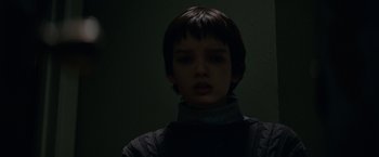 Movie still from “Let Me In” (2010), directed by Matt Reeves – A young boy with short black hair wearing a gray sweater; Close Up shot, Over the shoulder angle