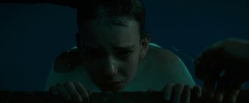 Movie still from “Let Me In” (2010), directed by Matt Reeves – A young boy is looking down at the floor; Close Up shot, Low angle