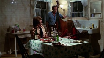 Movie still from “Let's Scare Jessica to Death” (1971), directed by John D. Hancock – A group of people sitting at a table with food; Wide shot, High angle