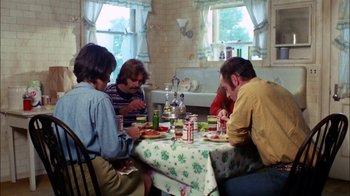 Movie still from “Let's Scare Jessica to Death” (1971), directed by John D. Hancock – A group of people sitting around a table eating food; Wide shot, High angle