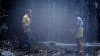 Movie still from “Let's Scare Jessica to Death” (1971), directed by John D. Hancock – A man and a woman standing in front of a waterfall; Wide shot, Low angle