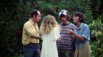 Movie still from “Let's Scare Jessica to Death” (1971), directed by John D. Hancock – A group of people standing next to each other in front of a tree; Medium shot, Overhead angle
