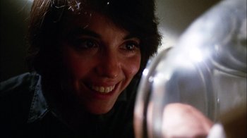 Movie still from “Let's Scare Jessica to Death” (1971), directed by John D. Hancock – A woman smiles while looking into a mirror; Close Up shot, Low angle
