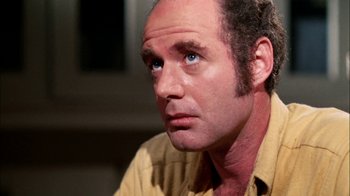 Movie still from “Let's Scare Jessica to Death” (1971), directed by John D. Hancock – A person sitting down with his eyes wide open; Close Up shot, Low angle