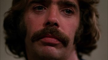 Movie still from “Let's Scare Jessica to Death” (1971), directed by John D. Hancock – A person with a mustache; Extreme Close Up shot, Low angle