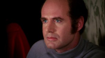 Movie still from “Let's Scare Jessica to Death” (1971), directed by John D. Hancock – A man with a bald head looking to his left; Close Up shot, Over the shoulder angle