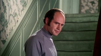 Movie still from “Let's Scare Jessica to Death” (1971), directed by John D. Hancock – A man standing in front of a stair case; Close Up shot, Low angle