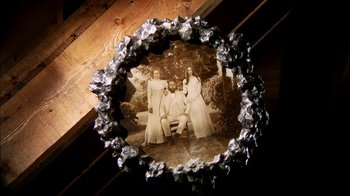 Movie still from “Let's Scare Jessica to Death” (1971), directed by John D. Hancock – An old photo of a family sitting on a park bench; Extreme Close Up shot, Overhead angle