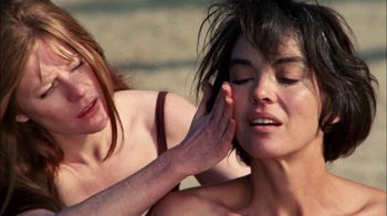 Movie still from “Let's Scare Jessica to Death” (1971), directed by John D. Hancock – Two women one of whom has her hand on the other's ear; Close Up shot, Over the shoulder angle