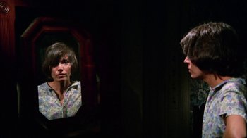Movie still from “Let's Scare Jessica to Death” (1971), directed by John D. Hancock – A woman looking in the mirror in front of a mirror; Close Up shot, Low angle