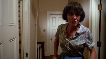 Movie still from “Let's Scare Jessica to Death” (1971), directed by John D. Hancock – A woman standing in front of a door in a room; Medium shot, Low angle