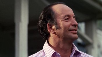 Movie still from “Let's Scare Jessica to Death” (1971), directed by John D. Hancock – An older man wearing a pink and white striped shirt; Close Up shot, Low angle