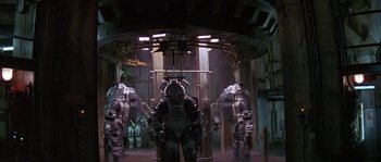 Movie still from “Leviathan” (1989), directed by George P. Cosmatos – A group of people standing next to each other in a room; Wide shot, High angle