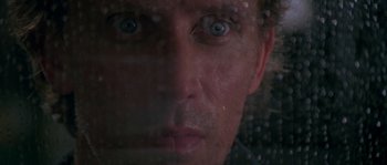 Movie still from “Leviathan” (1989), directed by George P. Cosmatos – A person's face through a window; Extreme Close Up shot, Low angle