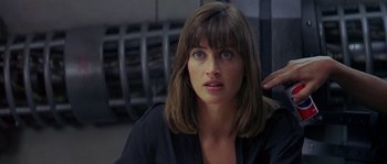 Movie still from “Leviathan” (1989), directed by George P. Cosmatos – A person with long brown hair; Close Up shot, Over the shoulder angle