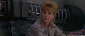 Movie still from “Leviathan” (1989), directed by George P. Cosmatos – A person sitting on a bench; Close Up shot, Over the shoulder angle