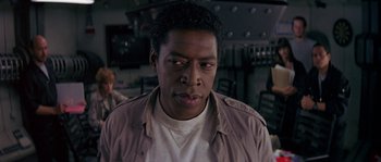 Movie still from “Leviathan” (1989), directed by George P. Cosmatos – A person wearing a shirt and a jacket; Close Up shot, Over the shoulder angle