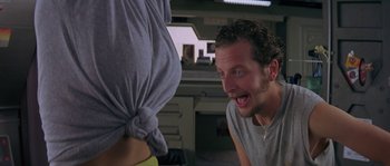 Movie still from “Leviathan” (1989), directed by George P. Cosmatos – A man is laughing at a woman in a gray shirt; Close Up shot, Over the shoulder angle