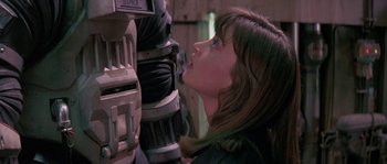 Movie still from “Leviathan” (1989), directed by George P. Cosmatos – A woman is looking at a machine in a room; Close Up shot, Low angle