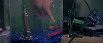 Movie still from “Leviathan” (1989), directed by George P. Cosmatos – A person touching a fish in an aquarium; Extreme Close Up shot, High angle