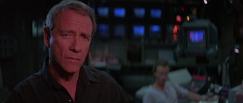 Movie still from “Leviathan” (1989), directed by George P. Cosmatos – A person in a black shirt; Close Up shot, Over the shoulder angle