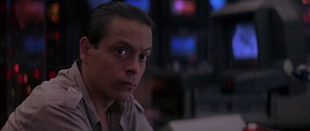 Movie still from “Leviathan” (1989), directed by George P. Cosmatos – A person sitting in front of a television; Close Up shot, Over the shoulder angle