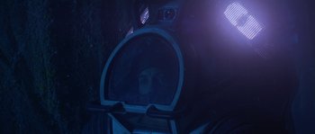 Movie still from “Leviathan” (1989), directed by George P. Cosmatos – A person is looking into a mirror in a train car; Close Up shot, Overhead angle