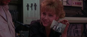 Movie still from “Leviathan” (1989), directed by George P. Cosmatos – A woman holding up an old picture of her family; Close Up shot, Over the shoulder angle