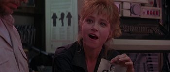 Movie still from “Leviathan” (1989), directed by George P. Cosmatos – A woman holding an old picture of herself in front of her face; Close Up shot, Over the shoulder angle